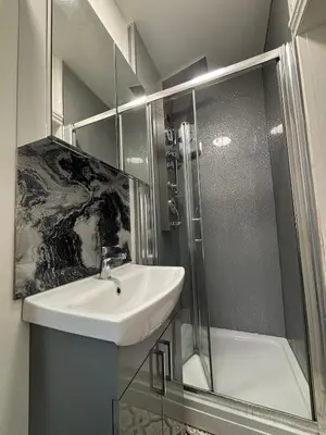 a bathroom with a sink and a shower at Shannon suite- Home away from Home-suitable for couples, contractors and NHS- free parking in Southport