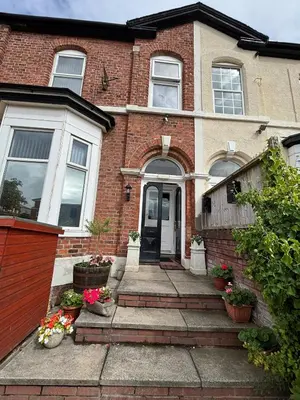 a brick house with a front door and stairs at Shannon suite- Home away from Home-suitable for couples, contractors and NHS- free parking in Southport