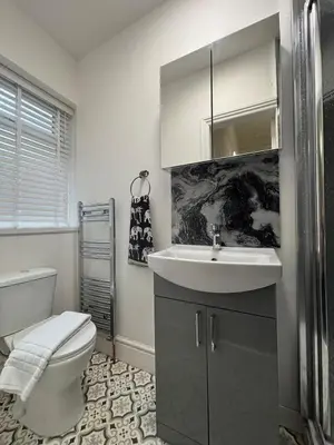 a bathroom with a sink and a toilet at Shannon suite- Home away from Home-suitable for couples, contractors and NHS- free parking in Southport