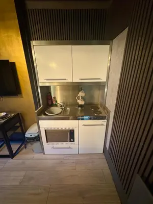 a small kitchen with a sink and a microwave at Reads Avenue - Luxury Ground Floor Studio - Next Door to H&A Social Club in Blackpool