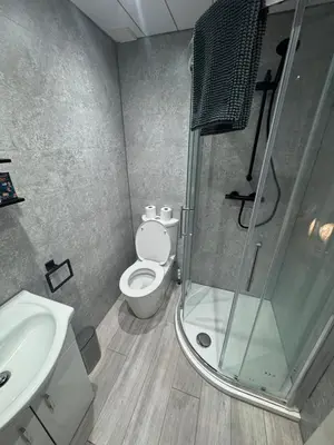 a bathroom with a shower and a toilet and a sink at Reads Avenue - Luxury Ground Floor Studio - Next Door to H&A Social Club in Blackpool