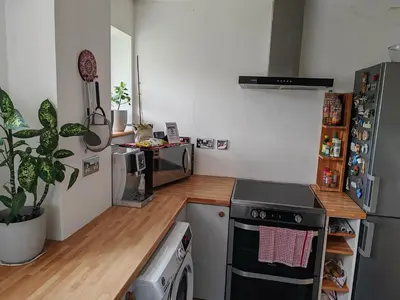 a small kitchen with a stove and a refrigerator at Peaceful Large Double Room l 55inch TV l Garden View in Egerton