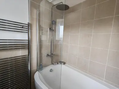 a bathroom with a shower and a bath tub at Peaceful Large Double Room l 55inch TV l Garden View in Egerton