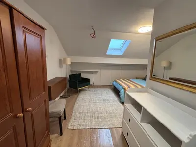 a bedroom with a bed and a sink and a mirror at Bedford Guesthouse in Liverpool