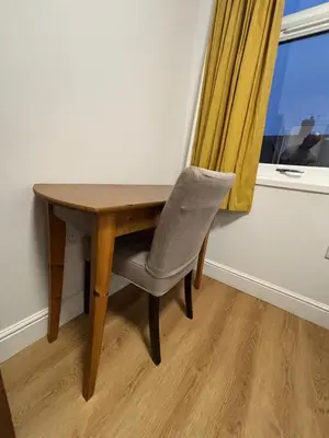 a wooden table and a chair next to a window at Bedford Guesthouse in Liverpool