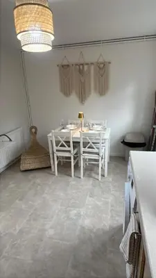a white dining room with a white table and chairs at Modern House on the Mersey in Wallasey