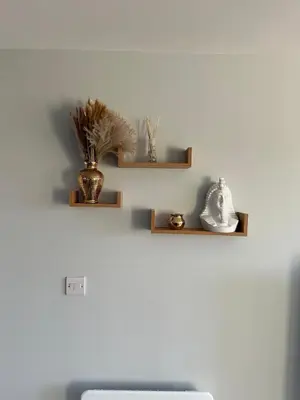 two shelves on a wall with a vase on it at Oriel Nubian walls in Liverpool
