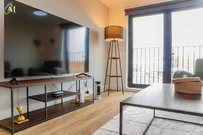 a living room with a table and a large mirror at Oriel Nubian walls in Liverpool