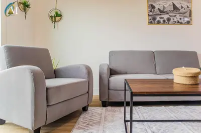 a living room with two chairs and a coffee table at Oriel Nubian walls in Liverpool