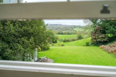 a view of a garden from a window of a house at Escowbeck House - Staycation - HotTub - Sleeps 8 in Lancaster