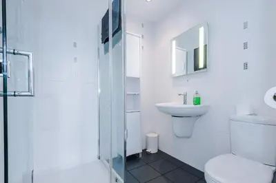 a white bathroom with a toilet and a sink at Escowbeck House - Staycation - HotTub - Sleeps 8 in Lancaster