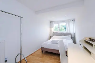 a white bedroom with a bed and a window at Escowbeck House - Staycation - HotTub - Sleeps 8 in Lancaster