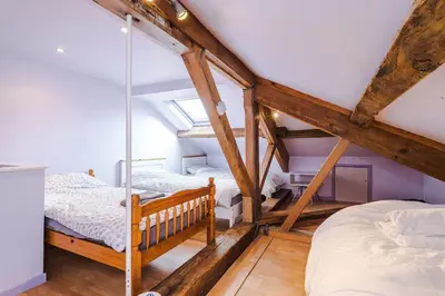 two beds in a attic room with wooden beams at Escowbeck House - Staycation - HotTub - Sleeps 8 in Lancaster