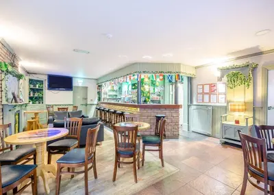 a restaurant with tables and chairs and a bar at Beacon Fell View in Longridge