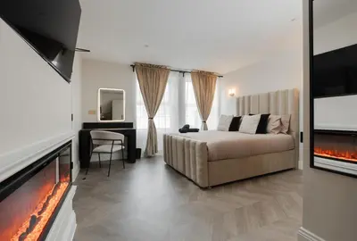 a bedroom with a bed and a flat screen tv at Bold St ApartHotel Book Individually or Book 8! in Liverpool