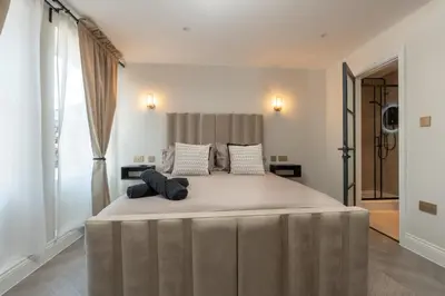 a large bed with two pillows on it in a bedroom at Bold St ApartHotel Book Individually or Book 8! in Liverpool