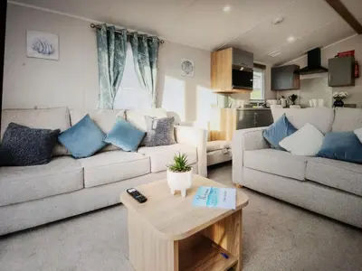 a living room with a couch and a table at Poppy Lodge LE 17 Ocean's Edge Park in Morecambe