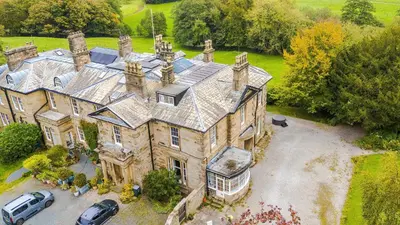 an aerial view of a large house with cars parked in front at Escowbeck House - Staycation - HotTub - Sleeps 10 in Caton