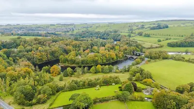 an aerial view of a park with a river and trees at Escowbeck House - Staycation - HotTub - Sleeps 10 in Caton