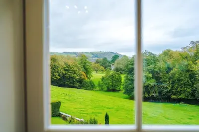a view of a field from a window at Escowbeck House - Staycation - HotTub - Sleeps 10 in Caton