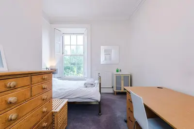 a bedroom with a bed and a dresser and a desk at Escowbeck House - Staycation - HotTub - Sleeps 10 in Caton