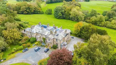 an aerial view of a mansion with cars parked in a parking lot at Escowbeck House - Staycation - HotTub - Sleeps 10 in Caton