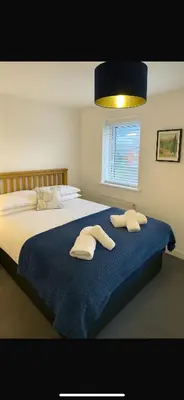 a bedroom with a large bed with towels on it at Lancaster Retreat in Lancaster
