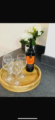a bottle of wine and three wine glasses on a tray at Lancaster Retreat in Lancaster