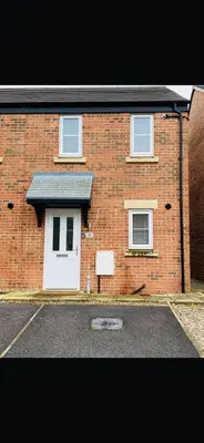 a brick house with a white door and windows at Lancaster Retreat in Lancaster