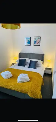 a bedroom with a large bed with towels on it at Lancaster Retreat in Lancaster
