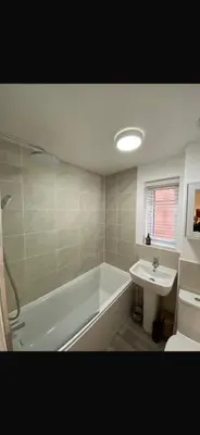 a bathroom with a bath tub and a sink at Lancaster Retreat in Lancaster