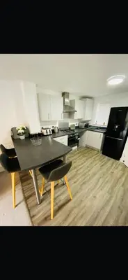 a kitchen with a table and chairs in a room at Lancaster Retreat in Lancaster