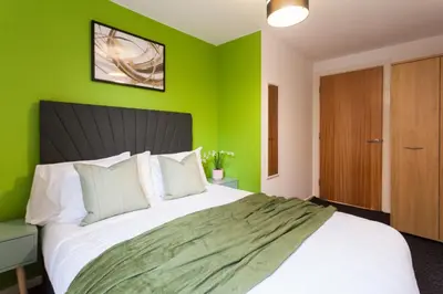 a bedroom with green walls and a large bed at Premium 10-Room Contractor Accommodation Central Location in Liverpool