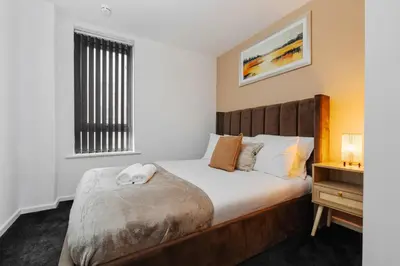 a bedroom with a bed and a window at Premium 10-Room Contractor Accommodation Central Location in Liverpool