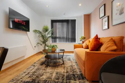 a living room with a couch and a table at Premium 10-Room Contractor Accommodation Central Location in Liverpool