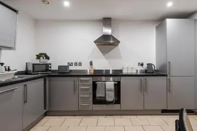 a kitchen with stainless steel cabinets and a stove at Premium 10-Room Contractor Accommodation Central Location in Liverpool