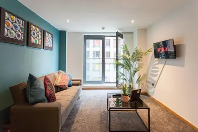 a living room with a couch and a table at Premium 10-Room Contractor Accommodation Central Location in Liverpool