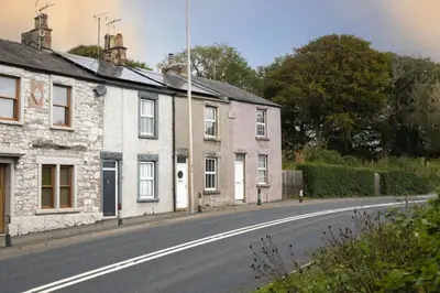 an empty street with houses on the side of a road at Three Bridges - 1-Mile from Ulverston Town Centre in Ulverston