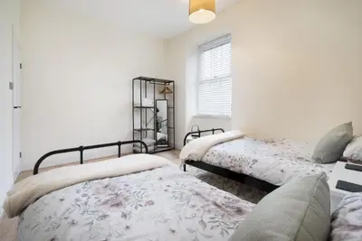 a bedroom with two beds and a window at Three Bridges - 1-Mile from Ulverston Town Centre in Ulverston
