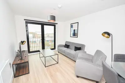a living room with a couch and a table at Fabulous Modern 2 Bedroom Apartment in Liverpool in Liverpool