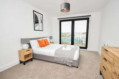 a bedroom with a bed and a large window at Fabulous Modern 2 Bedroom Apartment in Liverpool in Liverpool