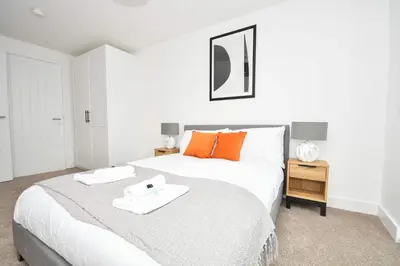 a bedroom with a bed with two towels on it at Fabulous Modern 2 Bedroom Apartment in Liverpool in Liverpool