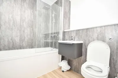 a bathroom with a toilet and a tub and a sink at Fabulous Modern 2 Bedroom Apartment in Liverpool in Liverpool