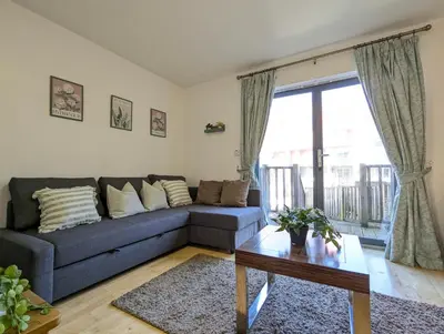 a living room with a couch and a table at Large 3-Bedrooms House Near Centre Free Parking in Liverpool