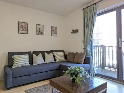 a living room with a blue couch and a table at Large 3-Bedrooms House Near Centre Free Parking in Liverpool
