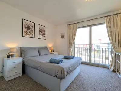 a bedroom with a bed and a large window at Large 3-Bedrooms House Near Centre Free Parking in Liverpool