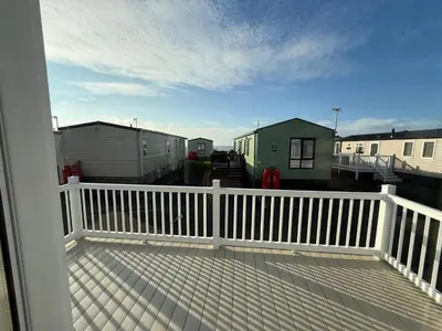 a balcony with a white fence and some houses at The Retreat LD 1A Oceans Edge in Morecambe