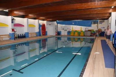 a large swimming pool with people in it at The Retreat LD 1A Oceans Edge in Morecambe