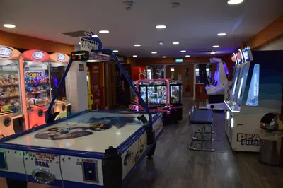 a room with arcade games and a video game at The Retreat LD 1A Oceans Edge in Morecambe