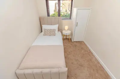 a small room with a bed and a window at Cosy city centre home - Wi-Fi - Free Parking in Preston